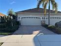 Two-car garage with brick paver driveway at 1910 Scarlett Ave, North Port, FL 34289