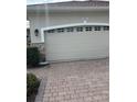 Two-car garage with paver driveway at 1910 Scarlett Ave, North Port, FL 34289