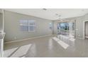 Bright and airy living room with tile floors and access to a screened patio at 1910 Scarlett Ave, North Port, FL 34289