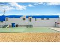 Side view of a white mobile home showing the exterior door and steps at 2107 Palma Sola Blvd # 13, Bradenton, FL 34209