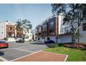 Rear view of townhouses with parking and landscaping at 2188 Fruitville Rd, Sarasota, FL 34237