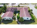 Two-unit building with red tile roofs and a shared courtyard at 2291 Pueblo Ln # V46, Sarasota, FL 34231