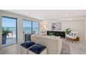 Bright living room with ocean views and comfy furniture at 2301 Gulf Of Mexico Dr # 52N, Longboat Key, FL 34228