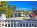 Front view of a charming house with a white picket fence at 2335 Novus St, Sarasota, FL 34237