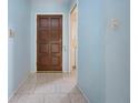 Light-blue walls and tiled floors in home entryway at 2413 Aspinwall St # 2413, Sarasota, FL 34237