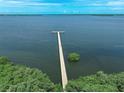 Stunning aerial view of a long pier extending into the beautiful bay waters at 2608 Edgewater Ct, Palmetto, FL 34221