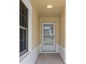 Front entry with a white door and sidelights, leading into the home at 2608 Edgewater Ct, Palmetto, FL 34221