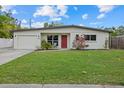 Updated home with red door and attached garage at 330 Caruso Pl, Sarasota, FL 34237