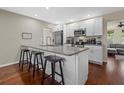 Modern kitchen with white cabinets, granite counters, and stainless steel appliances at 330 Caruso Pl, Sarasota, FL 34237