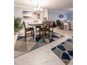 Elegant dining room featuring a large table and decorative rug at 3951 Lake Bayshore Dr # F408, Bradenton, FL 34205