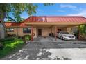 Condo exterior featuring carport and landscaping at 4108 La Costa Cv, Bradenton, FL 34210