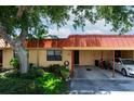 Condo exterior with carport and lush landscaping at 4108 La Costa Cv, Bradenton, FL 34210