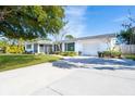 White house with green accents and a large driveway at 4515 Falcon Ridge Dr, Sarasota, FL 34233