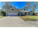 House exterior showcasing a two-car garage and landscaping at 4822 30Th Street E Ct, Bradenton, FL 34203