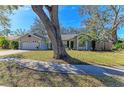 Single-story house with a large tree in the front yard at 4822 30Th Street E Ct, Bradenton, FL 34203