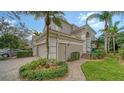 Beautiful exterior view with a brick walkway leading to the front entrance and lush landscaping at 5208 Parisienne Pl # 202B33, Sarasota, FL 34238