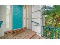 Inviting front entrance with a vibrant turquoise door, brick steps, and manicured landscaping at 5208 Parisienne Pl # 202B33, Sarasota, FL 34238