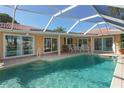 Relaxing pool area with covered patio and seating at 521 Wedge Ln, Longboat Key, FL 34228