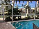 Inviting pool with canal view and screened enclosure at 521 Wedge Ln, Longboat Key, FL 34228