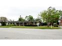 Green house with well-manicured lawn and landscaping at 5415 8Th Avenue W Dr, Bradenton, FL 34209