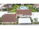 Aerial view showing condo building, pool, and surrounding landscape at 5940 7Th W Ave # 5940, Bradenton, FL 34209