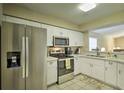 Modern kitchen with stainless steel appliances and white cabinets at 6115 39Th W Ave, Bradenton, FL 34209