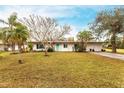 Charming updated mid-century home with teal door and spacious yard at 6222 Brentwood Ave, Sarasota, FL 34231