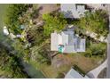 Bird's eye view of waterfront property, showcasing the house and canal at 6821 Longboat S Dr, Longboat Key, FL 34228