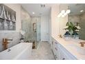 Elegant bathroom with double vanity, soaking tub, and walk-in shower at 719 Maldives Trl, Sarasota, FL 34234