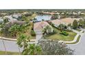 Bird's-eye view of a house in a residential community near a lake at 7204 Annanhill Ln, Lakewood Ranch, FL 34202