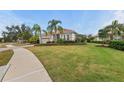 House with a paved walkway, lush lawn and palm trees at 7204 Annanhill Ln, Lakewood Ranch, FL 34202