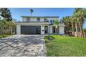 Charming home boasts a manicured lawn, palm trees, and modern garage door, enhancing its curb appeal at 7324 Phillips St, Sarasota, FL 34243