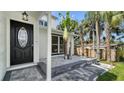 Inviting front porch featuring stone accents and lush greenery at 7324 Phillips St, Sarasota, FL 34243