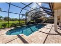 Inviting screened-in pool and spa with a beautiful golf course view at 7503 Calle Facil, Sarasota, FL 34238