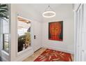 Bright entryway with large Buddha painting and tile floor at 7755 Pine Trace Dr # 7755, Sarasota, FL 34243