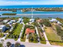 Aerial view of property showing its proximity to the water and surrounding houses in a coastal area at 935 Bayshore Rd, Nokomis, FL 34275