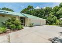 Attached three-car garage with additional parking area at 1130 Anclote Rd Rd, Tarpon Springs, FL 34689