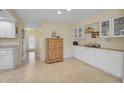 Bright kitchen boasts white cabinets, tile floors, and ample counter space at 1212 Windward Dr, Osprey, FL 34229