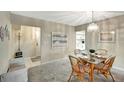 Bright dining room with glass table and wicker chairs at 1255 E Peppertree Dr # 402, Sarasota, FL 34242