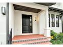 Modern townhome front door with tiled entryway at 1273 Boulevard Of The Arts, Sarasota, FL 34236