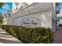 Building exterior featuring landscaping and building signage at 166 Golden Gate Pt # 21, Sarasota, FL 34236