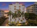 Luxury building with palm trees and waterfront access at 166 Golden Gate Pt # 21, Sarasota, FL 34236