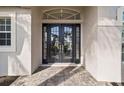 Elegant front entrance with double doors and a stone walkway at 2115 Calusa Lakes Blvd, Nokomis, FL 34275