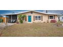 Ranch style home with teal front door and landscaping at 2206 25Th W Ave, Bradenton, FL 34205