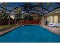 Inviting screened pool and spa with comfortable seating area at 2232 Elcid Ct, Palm Harbor, FL 34683