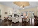 Elegant living room with hardwood floors, fireplace, and ample natural light at 230 Osprey Point Dr, Osprey, FL 34229