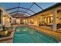 Inviting pool area with a covered lanai and comfortable seating at 230 Osprey Point Dr, Osprey, FL 34229