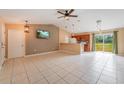 Open living room and kitchen with tile floors and high ceilings at 2415 Nowatney Ave, North Port, FL 34286