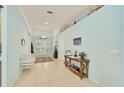 Bright foyer with tile flooring, complemented by a decorative table and stylish decor at 2925 122Nd E Pl, Parrish, FL 34219