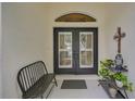 Inviting front porch featuring double doors, a welcome sign, and charming decorative elements at 2925 122Nd E Pl, Parrish, FL 34219